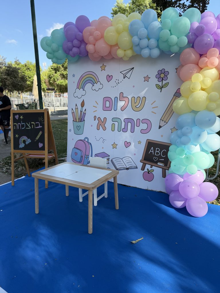 מופע אמנים צבעוני עם קישוטי בלונים בנושא בית ספר לאירוע שלום כיתה א׳